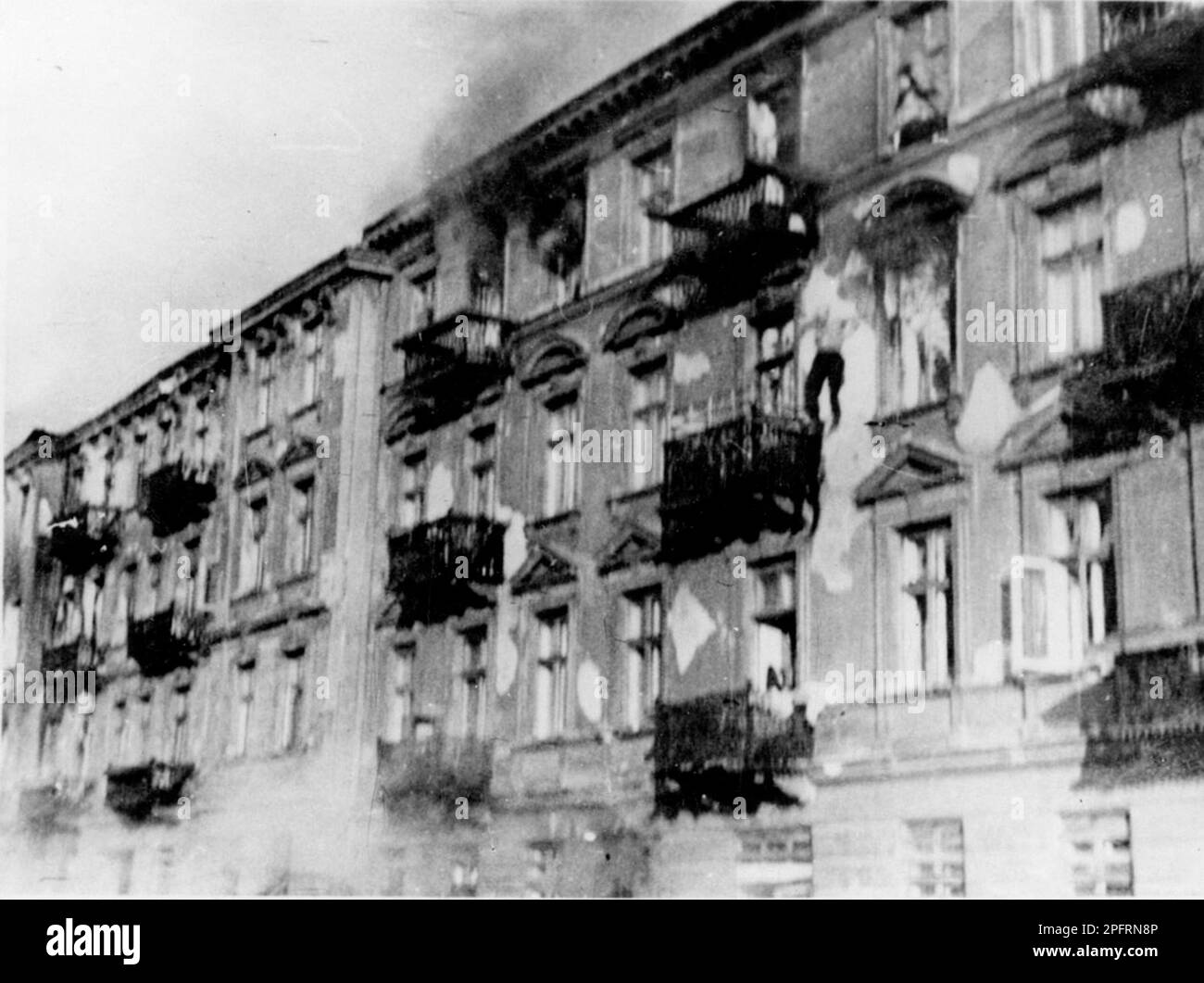 In January 1943 the nazis arrived to round up the Jews of the Warsaw Ghetto  The Jews, resolved to fight it out, took on the SS with homemade and primitive weapons. The defenders were executed or deported and the Ghetto area was systematically demolished. This event is known as The Ghetto Uprising.. This image shows a man falling to his death rather than be caught. This image is from the German photographic record of the event, known as the Stroop report. Stock Photo