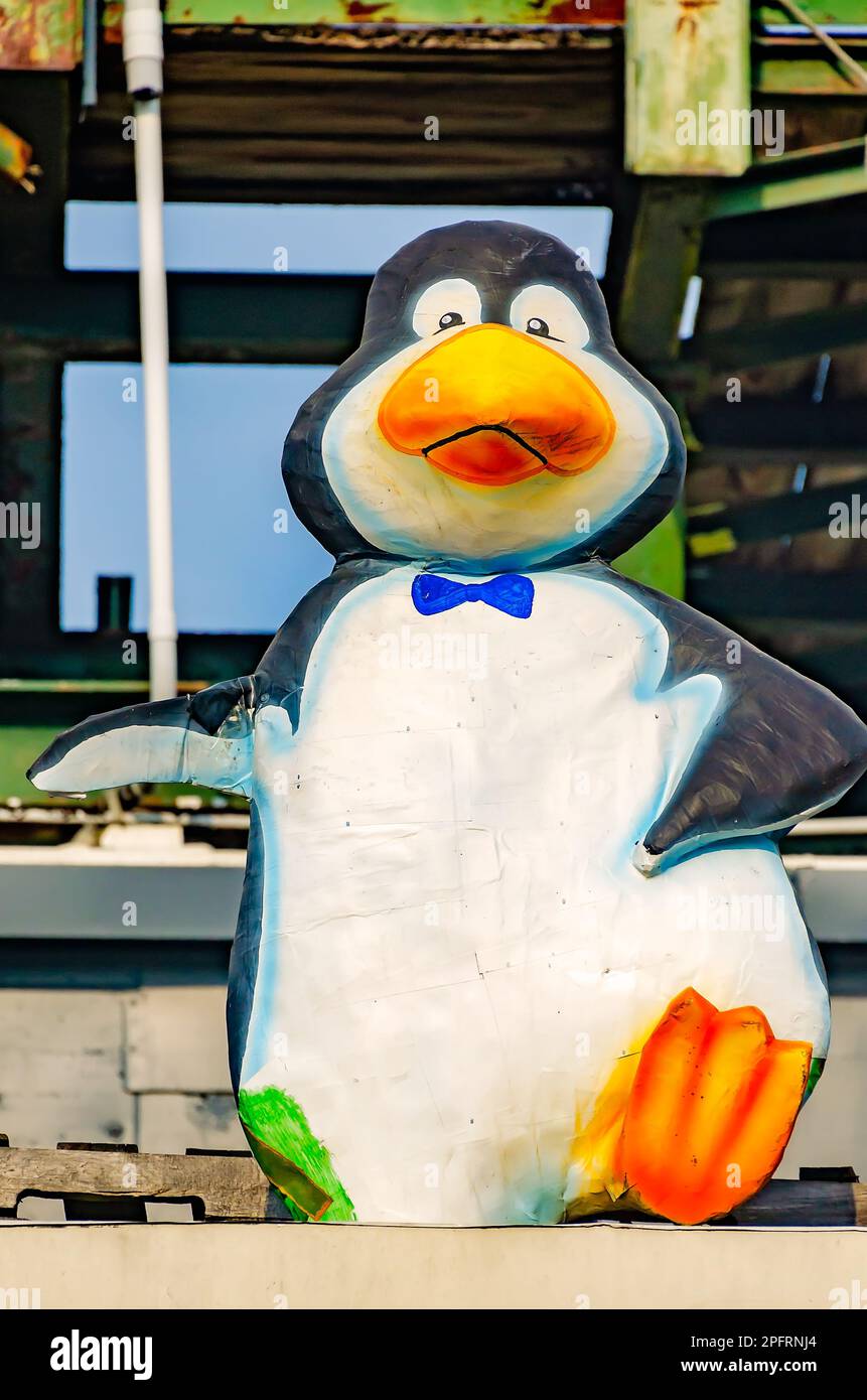 A plastic penguin dances on the rooftop of The Ice Box bar, March 8, 2023, in Mobile, Alabama. Stock Photo