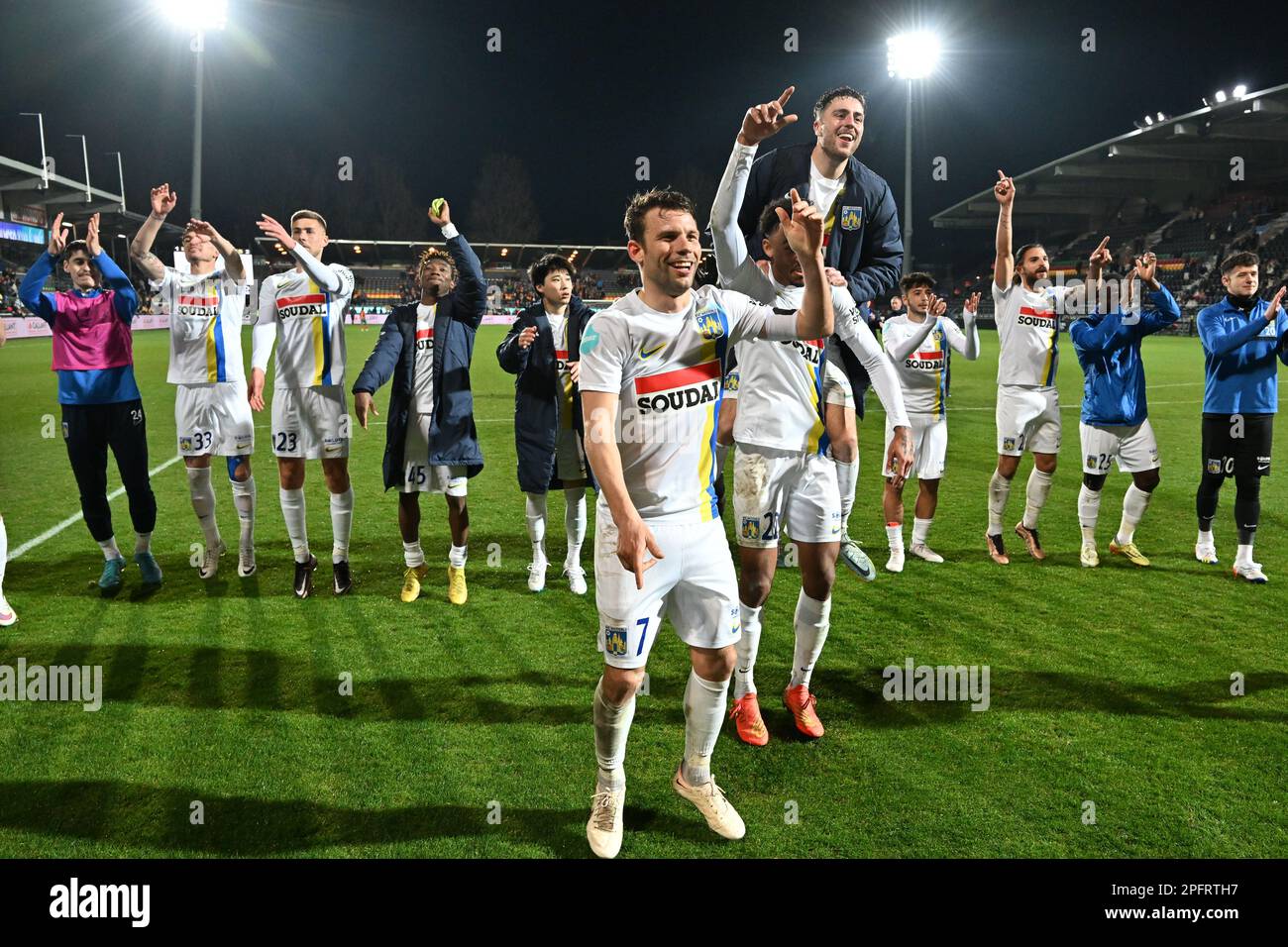 Westerlo's players, Westerlo's Lukas Van Eeno and Westerlo's Bryan Reynolds  celebrate after winning a soccer match between KV Oostende and KVC Westerlo,  Saturday 18 March 2023 in Oostende, on day 30 of