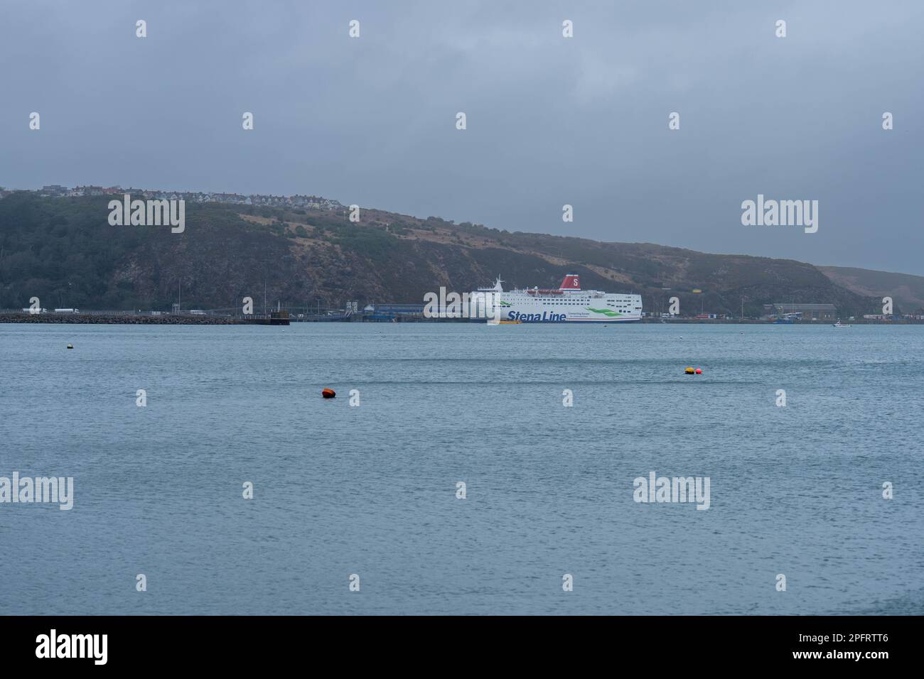 View of Fishgaurd harbour with Stenna Line ship in distance Stock Photo
