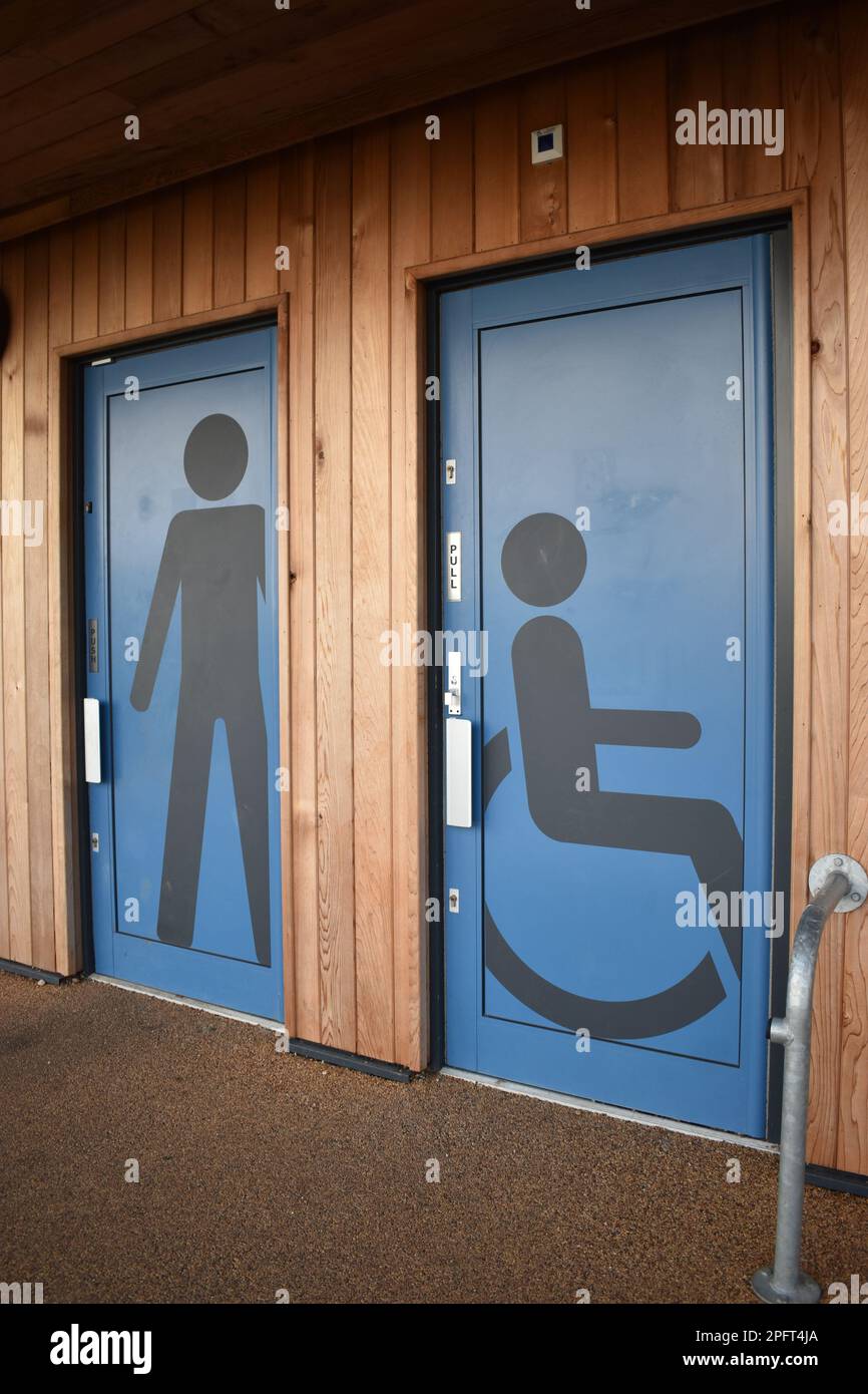 Two blue toilet doors, one with a male figure, the other with a wheelchair symbol at Willen Lake in Milton Keynes. Stock Photo