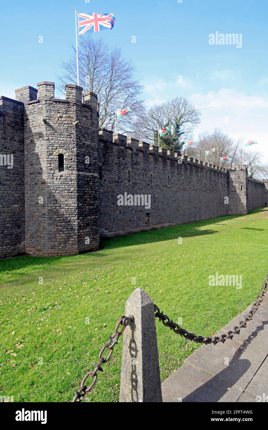 Cardiff Castle outer walls with Welsh and Union flags flying. March 2023. Stock Photo