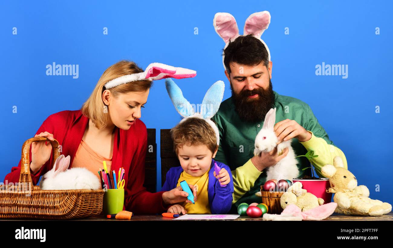 Easter day celebration. Easter Family traditions. Cute child boy and parents in bunny ears. Happy family preparing for Easter day. Mother, father and Stock Photo