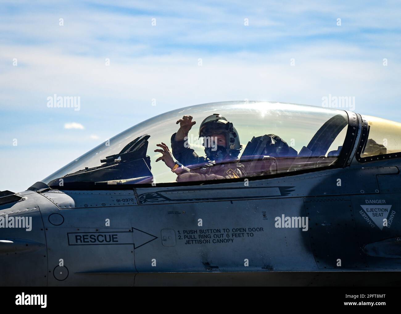 A U.S. Air Force pilot assigned to the 79th Fighter Squadron displays the squadron’s signature “Tiger, Tiger” hand signal during the first day of exercise Red Flag-Nellis 23-2 at Nellis Air Force Base, Nevada, March 13, 2023. Through dedicated training opportunities like RFN 23-2, Wild Weasels work to maintain combat readiness so they can ensure the collective defense of the United States and their partners and allies. (U.S. Air Force photo by Staff Sgt. Madeline Herzog) Stock Photo