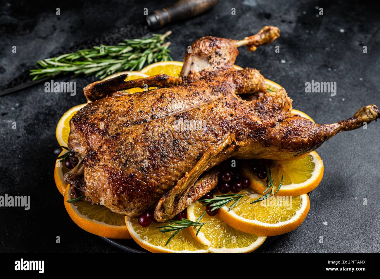 Christmas dinner, baked duck with rosemary and oranges, crispy whole