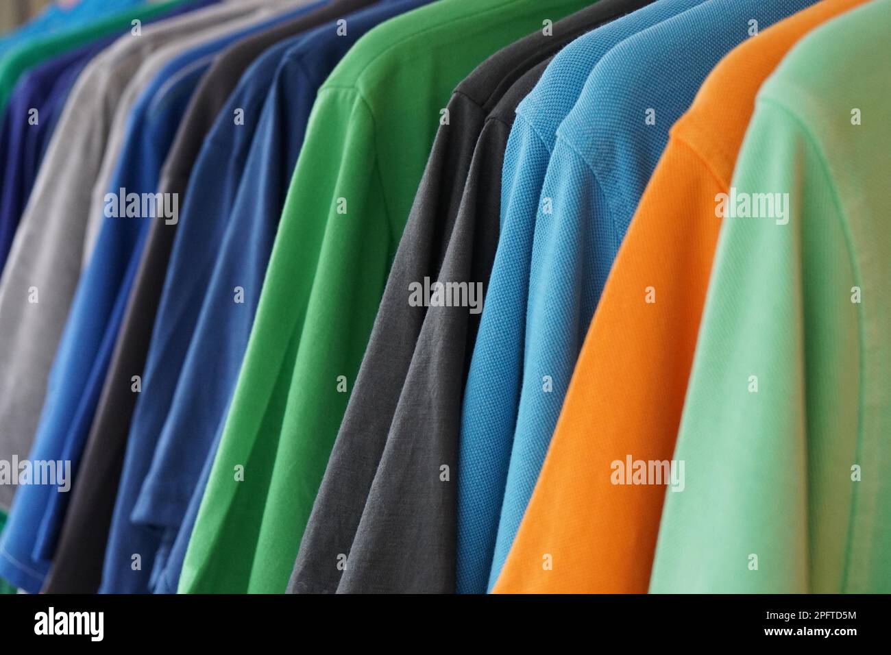 clothes rack with multicolored men's polo shirts Stock Photo