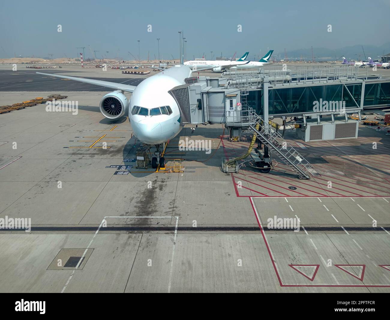 Hong Kong March 1, 2023 Airplane at boarding gate jet bridge in Hong