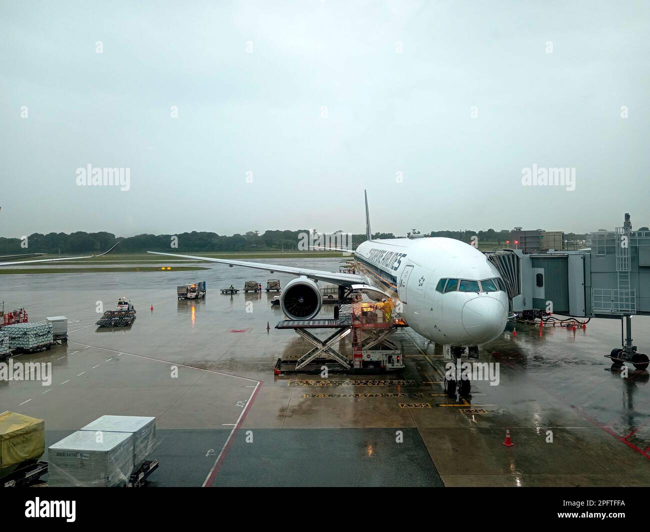 Singapore March 1, 2023 Airplane at boarding gate jet bridge in Hong