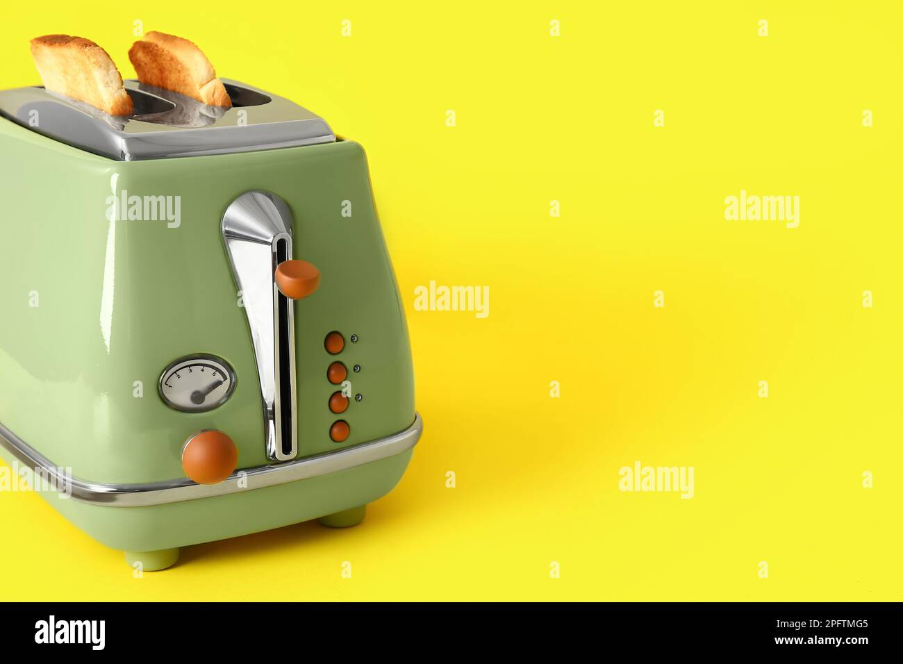 Modern toaster with crispy bread slices on yellow background Stock ...