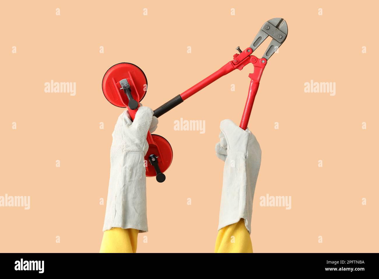 Female worker with tools on beige background Stock Photo