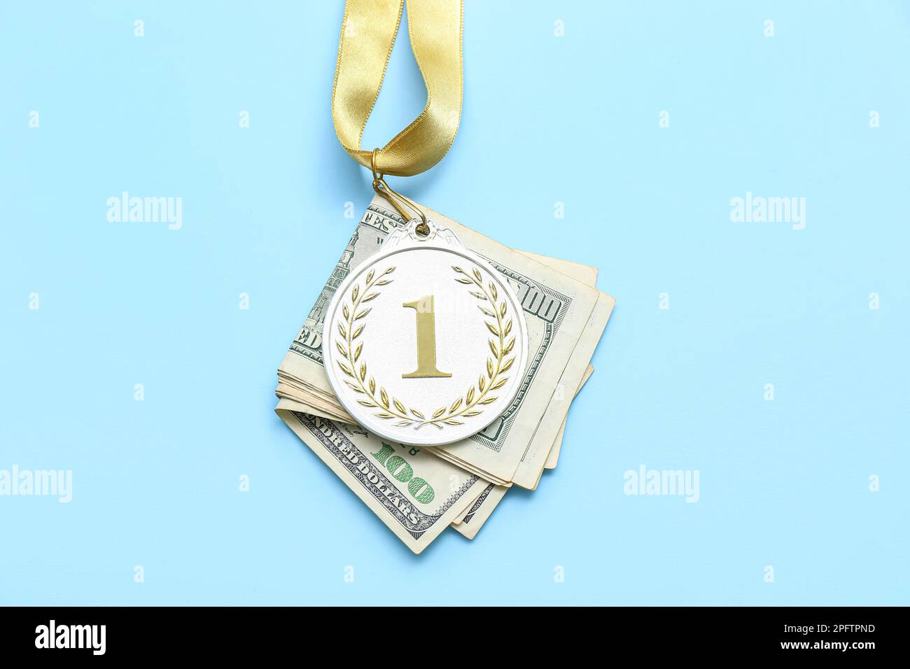 First place medal with money on blue background Stock Photo