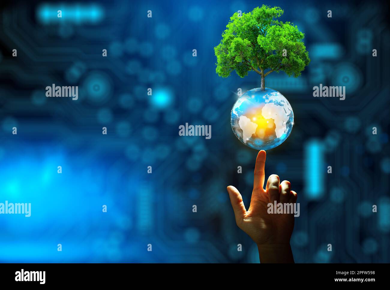 Hand pointing growing tree on crystal ball with technological ...