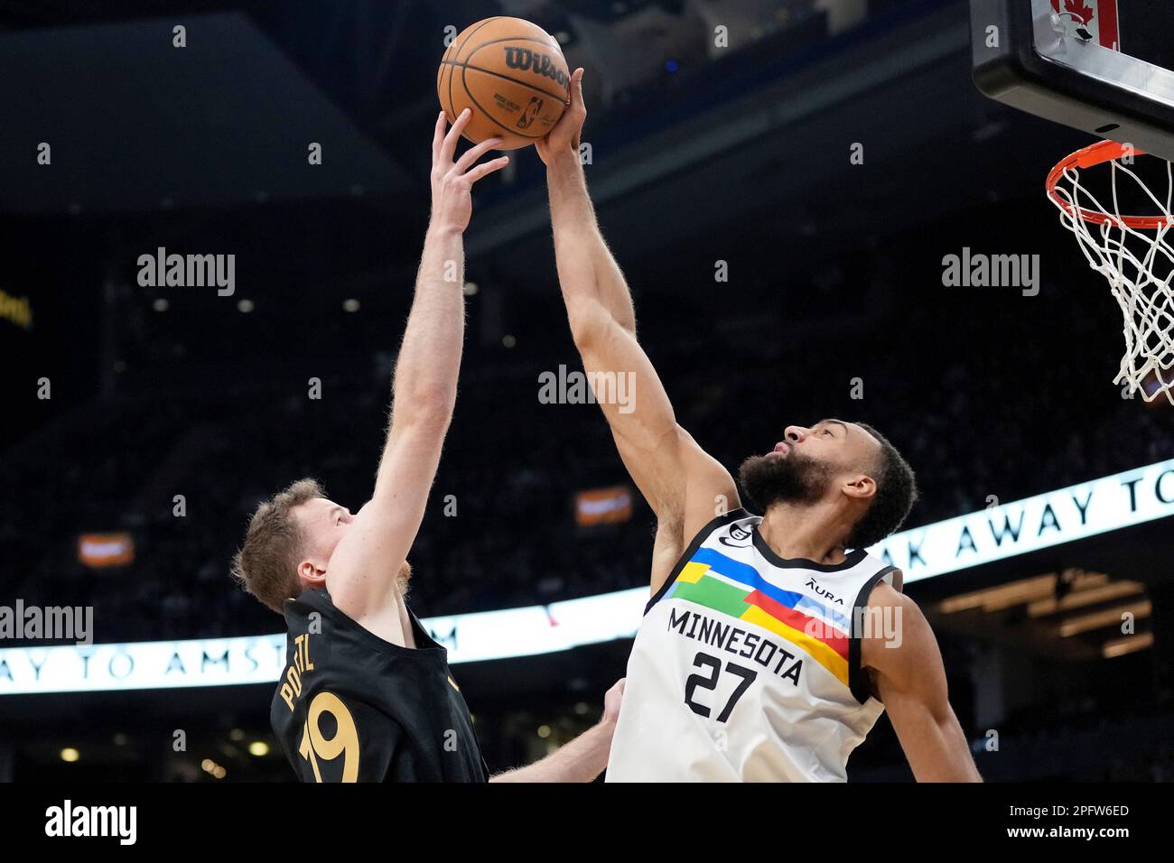 March 18, 2023, Toronto, ON, CANADA: Minnesota Timberwolves centre Rudy  Gobert (27) blocks a shot by Toronto Raptors centre Jakob Poeltl (19)  during first half NBA basketball action in Toronto, Saturday, March