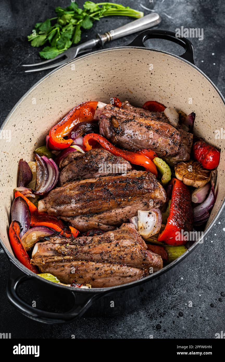 Braised slow cooked lamb shank in red wine sauce with vegetables in