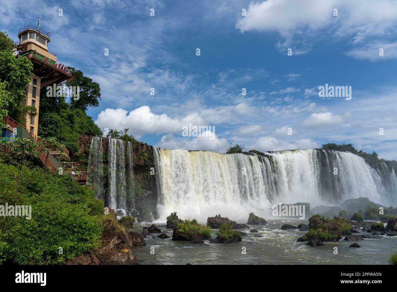 The Observation tower with unrecognized people and view of the Iguazu Falls in the National Park in Foz do Iguacu, Brazil. The Iguazu NP is an attract Stock Photo