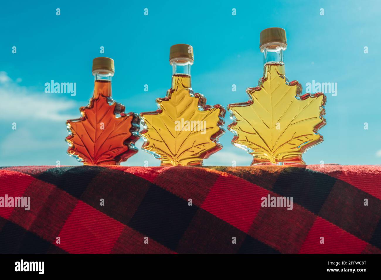 Maple syrup bottles in leaf shape outside. Selection of different