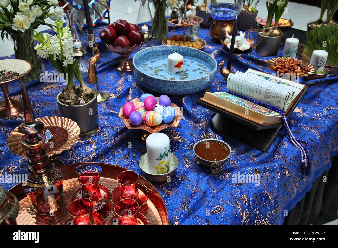 Traditional items adorn a Haft Sin (Haft Seen) (an arrangement of seven symbolic items that all begin with the letter S in Farsi) during Nevruz celebrations in Toronto, Canada, on March 18, 2023. Nevruz (Norooz, Nourooz, Newroz, Nowruz) which means 'new day' marks the first day of Spring, and is also celebrated in Iran, Afghanistan, Azerbaijan, Albania, Bashkortostan, Bahrain, Georgia, Turkmenistan, Tajikistan, Uzbekistan, Kyrgyzstan and Kazakhstan, as well as among various other Iranian and Turkic peoples in Iraqi Kurdistan, Syria, Lebanon, Pakistan, India, northwestern China, the Caucasus, t Stock Photo