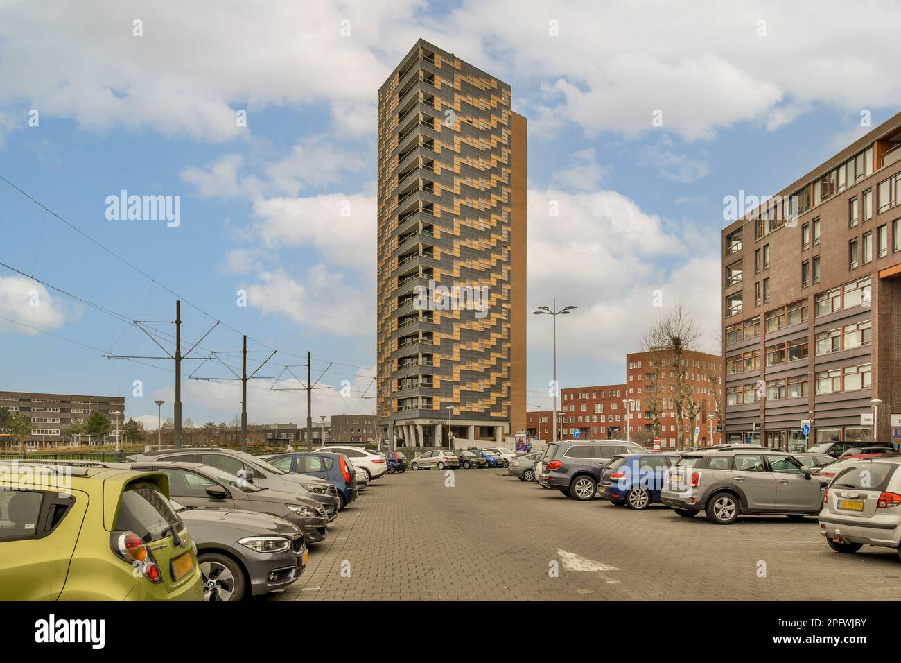 a city street with cars parked on the side and tall buildings in the ...