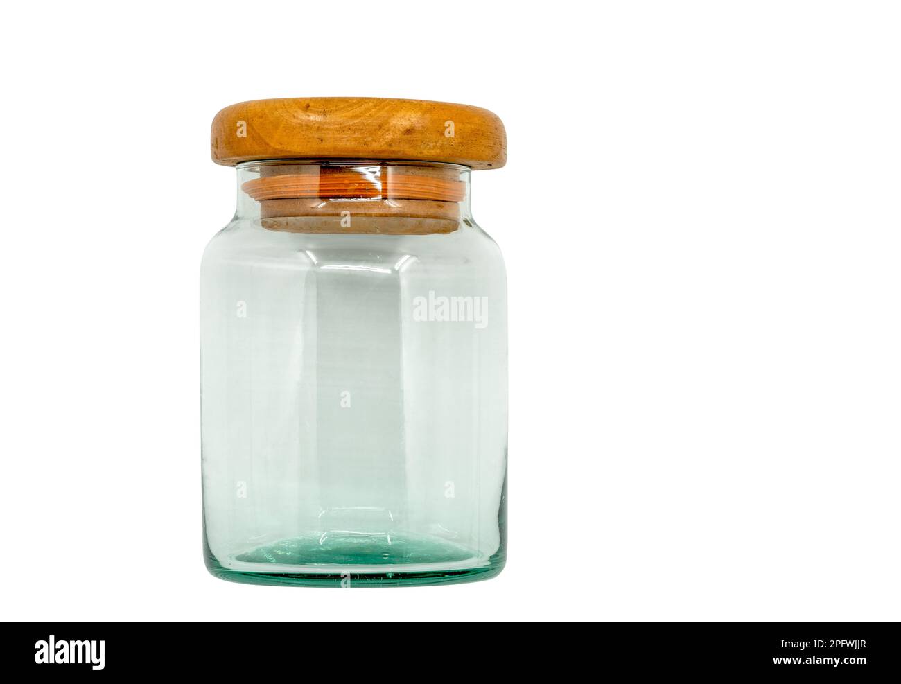 Isolated old glass jar with wooden lid. Vintage glass jar on white