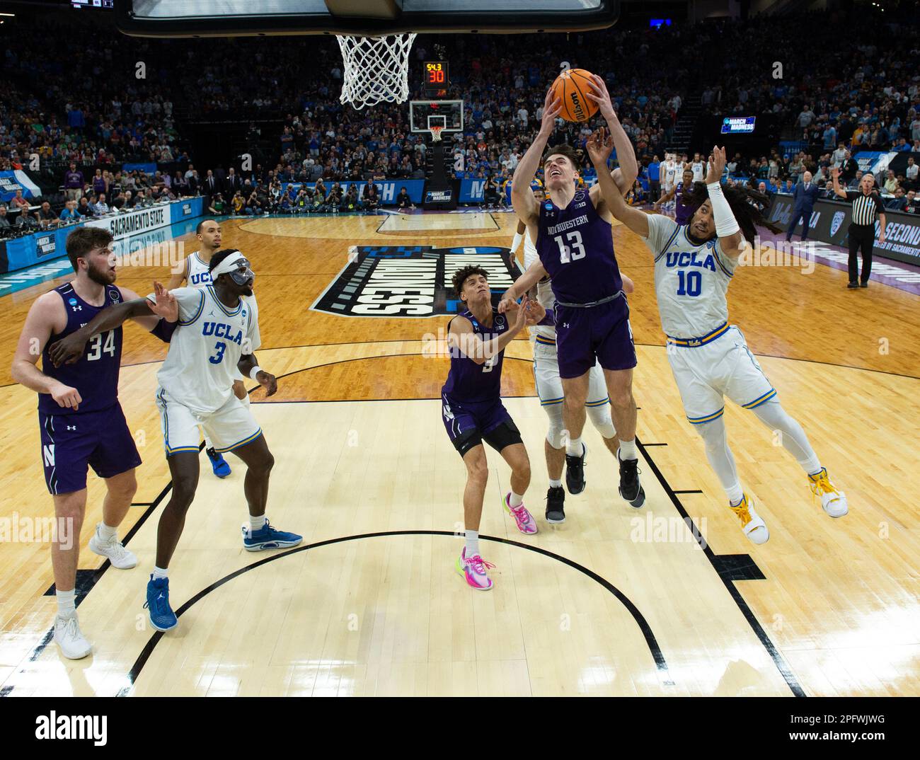 Sacramento, CA, USA. 18th Mar, 2023. UCLA Bruins guard Tyger Campbell (10) defends on drive to basket by Northwestern Wildcats guard Brooks Barnhizer (13) during a game in the NCAA Tournament at Golden 1 Center in Sacramento, Saturday, March 18, 2023. Princeton Tigers beat the Missouri Tigers 78-63. (Credit Image: © Paul Kitagaki Jr./ZUMA Press Wire) EDITORIAL USAGE ONLY! Not for Commercial USAGE! Stock Photo
