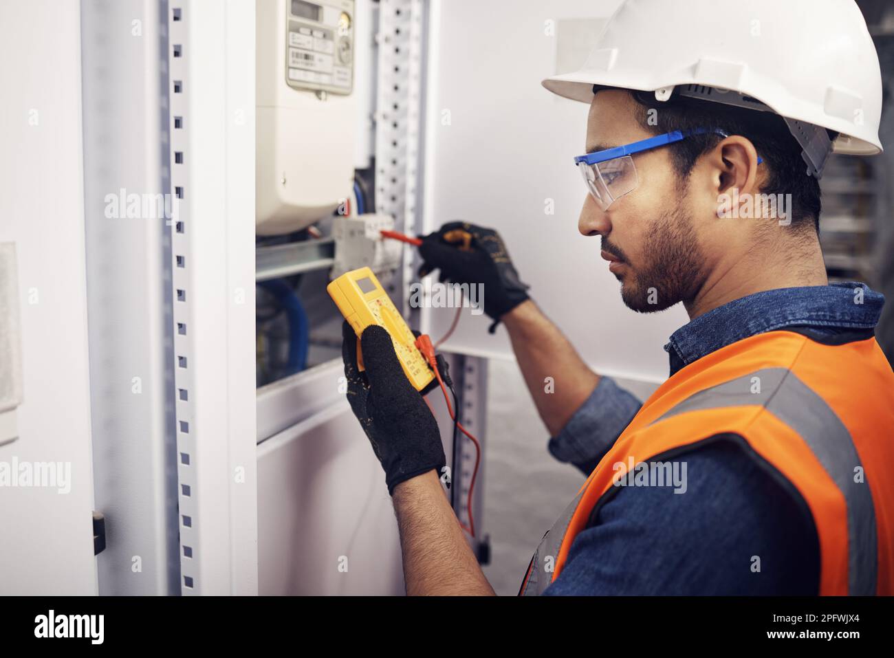 Technician, man and multimeter testing power for electricity, energy inspection and electrical