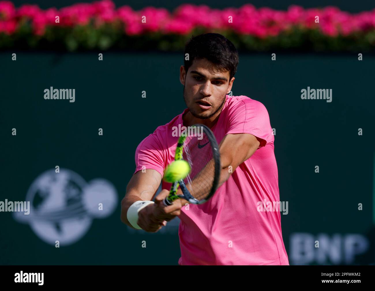 March 18, 2023 Carlos Alcaraz of Spain returns a shot against Jannik Sinner of Italy during a semifinal match at the 2023 BNP Paribas Open at Indian Wells Tennis Garden in Indian