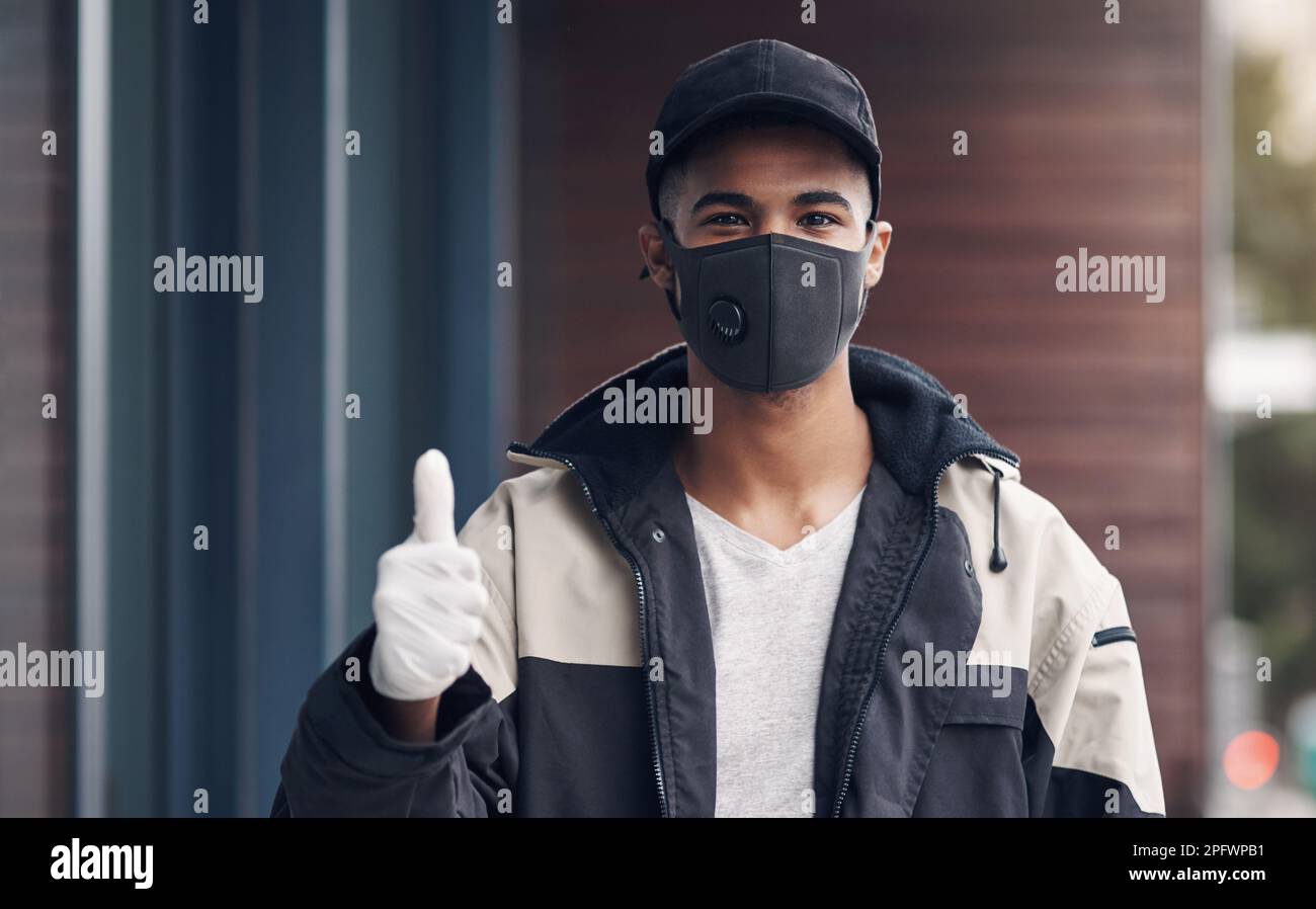Im putting your safety first. a masked young man showing thumbs while ...