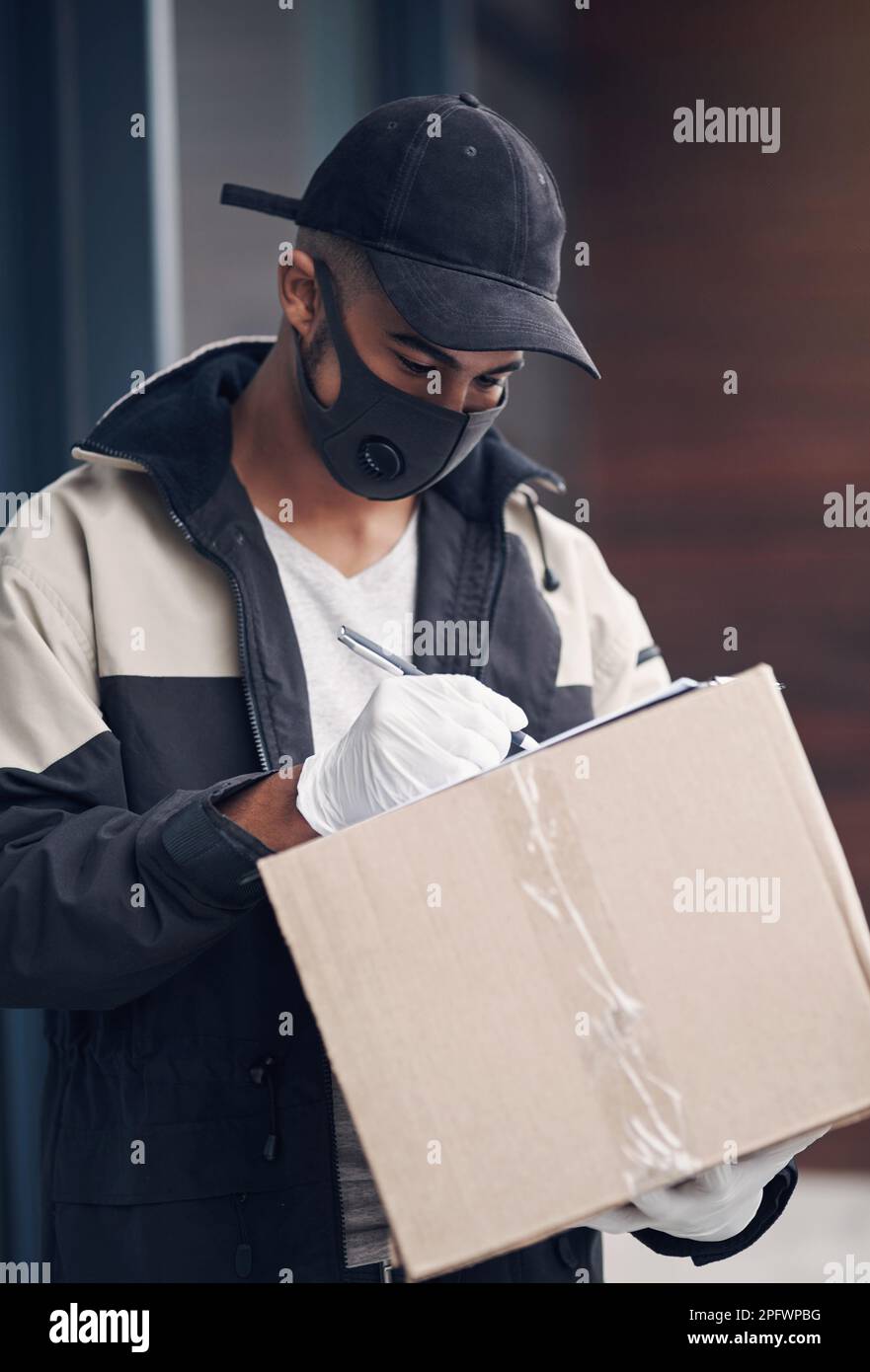 Masked young man standing outdoors hi-res stock photography and images ...