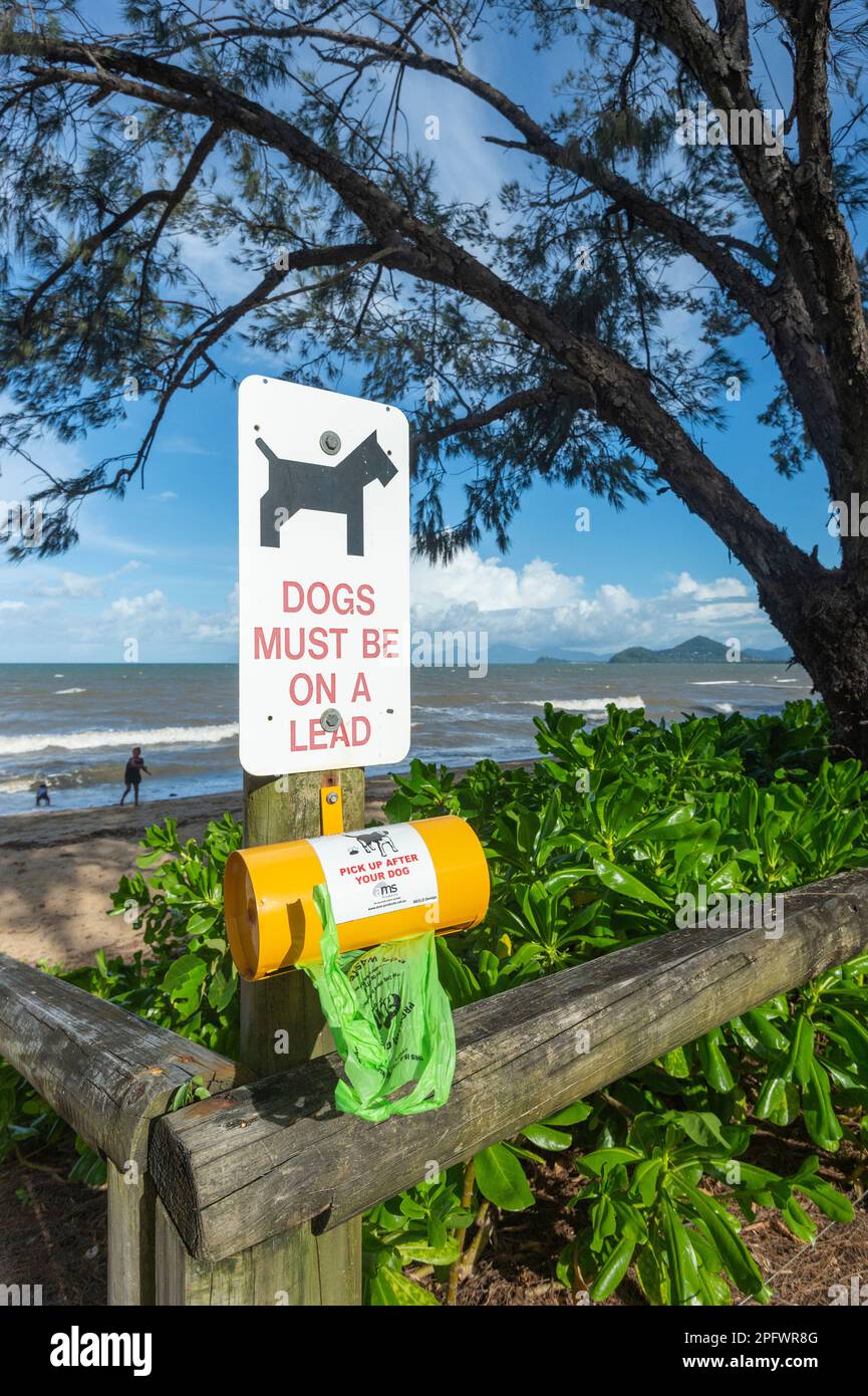 Dogs must be on a lead sign, along a dog bag dispenser, Cairns Northern Beaches, Far North Queensland, FNQ, QLD, Australia Stock Photo
