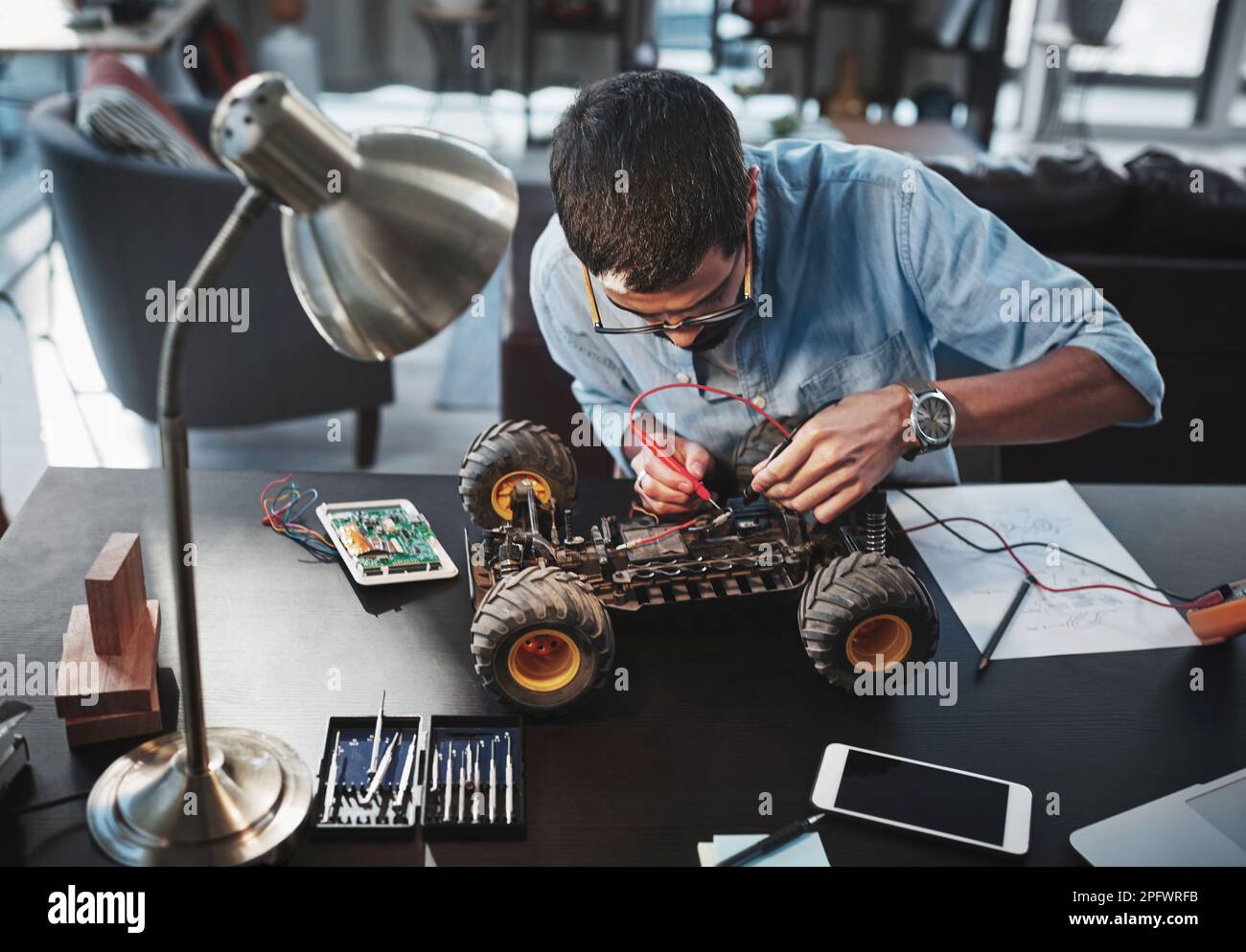 Working on his latest invention. a young engineer working from home. Stock Photo