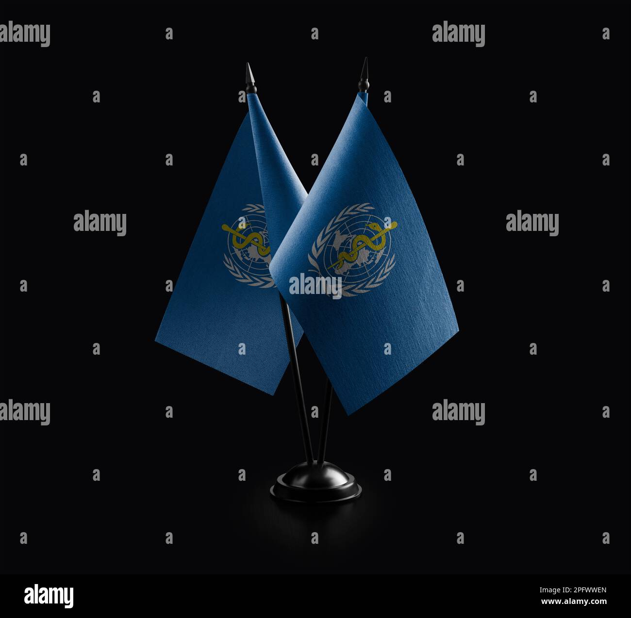 Small national flags of the World Health Organization WHO on a black ...