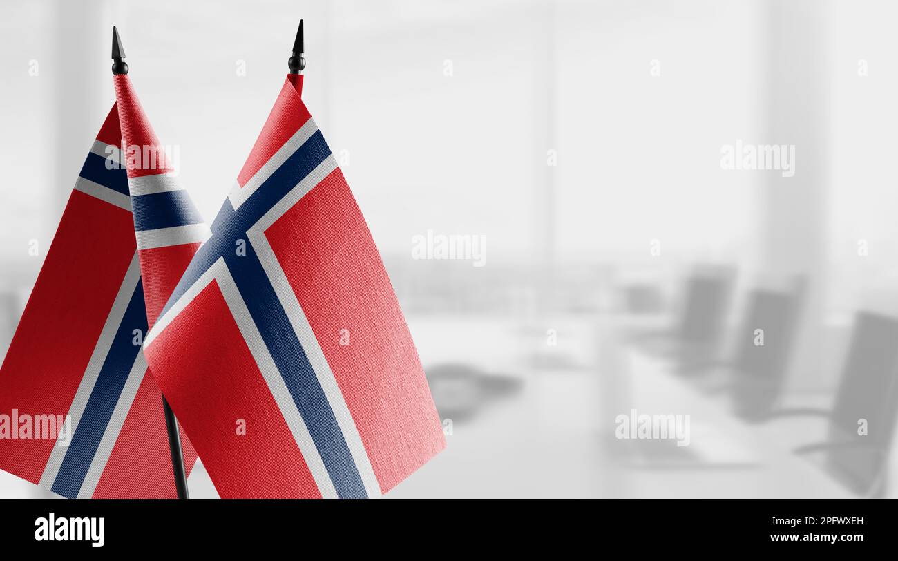 Small flags of the Norway on an abstract blurry background Stock Photo ...