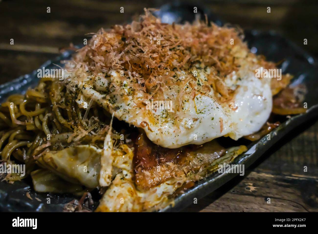 Okonomiyaki, Japanese pancake served on plate Stock Photo Alamy