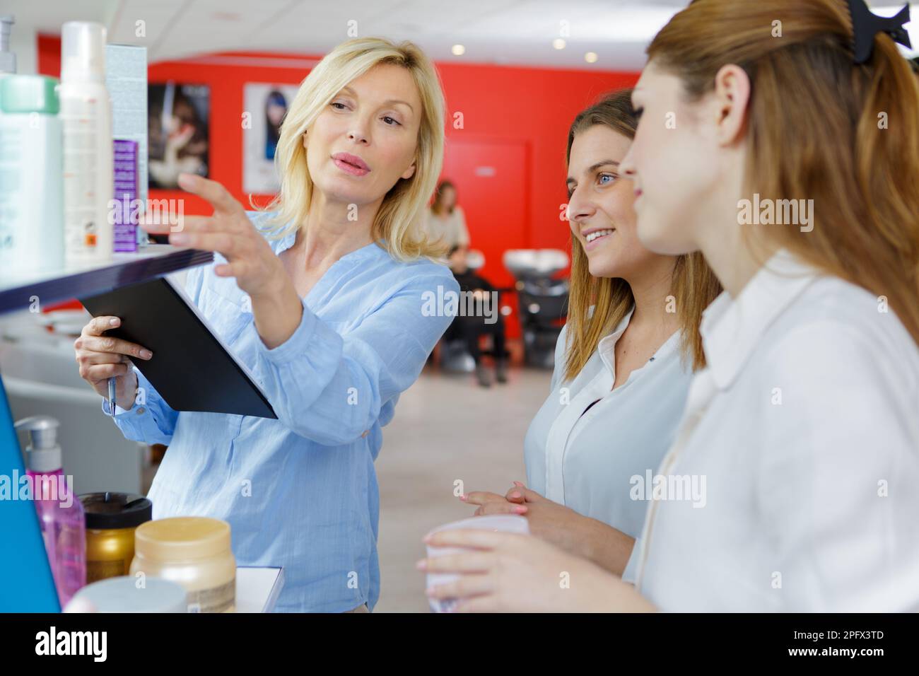 hairdressing apprentices learning the product Stock Photo Alamy