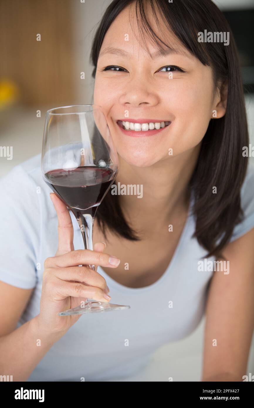 woman holding wine glass smiling Stock Photo - Alamy