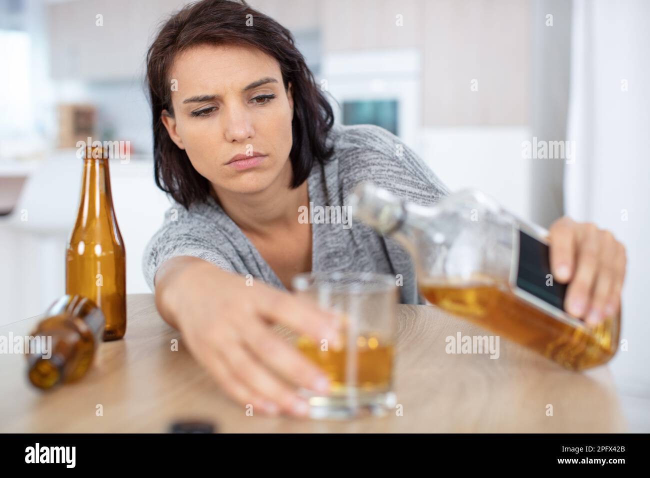 lonely and thirsty woman having a problem with alcohol Stock Photo