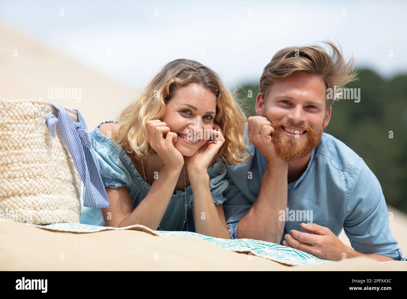 happy young couple lying on beach Stock Photo - Alamy