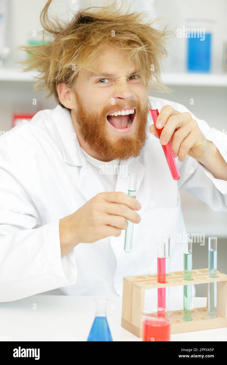 crazy alchemist checks the test tubes Stock Photo