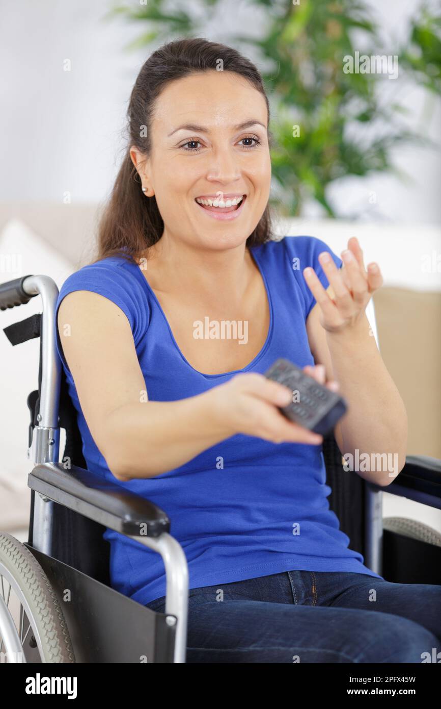 Woman pressing remote control hi-res stock photography and images - Alamy