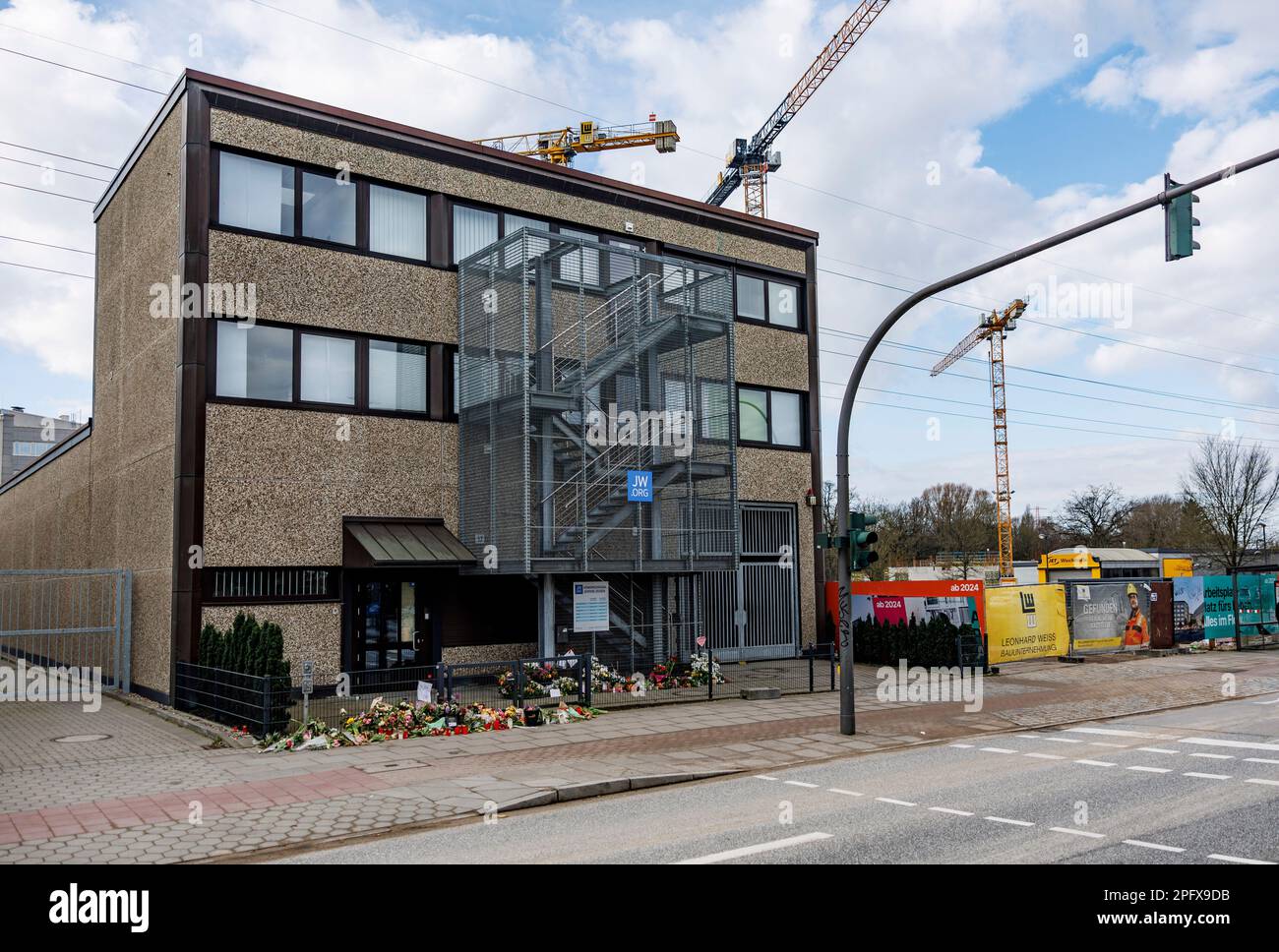 Hamburg, Germany. 19th Mar, 2023. Flowers are laid at the building where 35-year-old Philipp F. shot seven people, including an unborn child, in Hamburg-Alsterdorf. A memorial service is held for the victims of the rampage in Hamburg. Credit: Axel Heimken/dpa/Alamy Live News Stock Photo