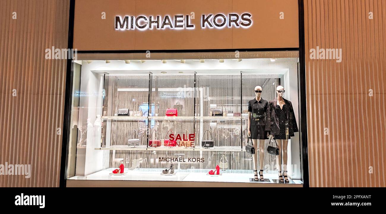 Austria, Vienna - January 7, 2023: Michael Kors - clothing and accessories store. Fashion boutique of famous American designer. Mannequins, bags and s Stock Photo