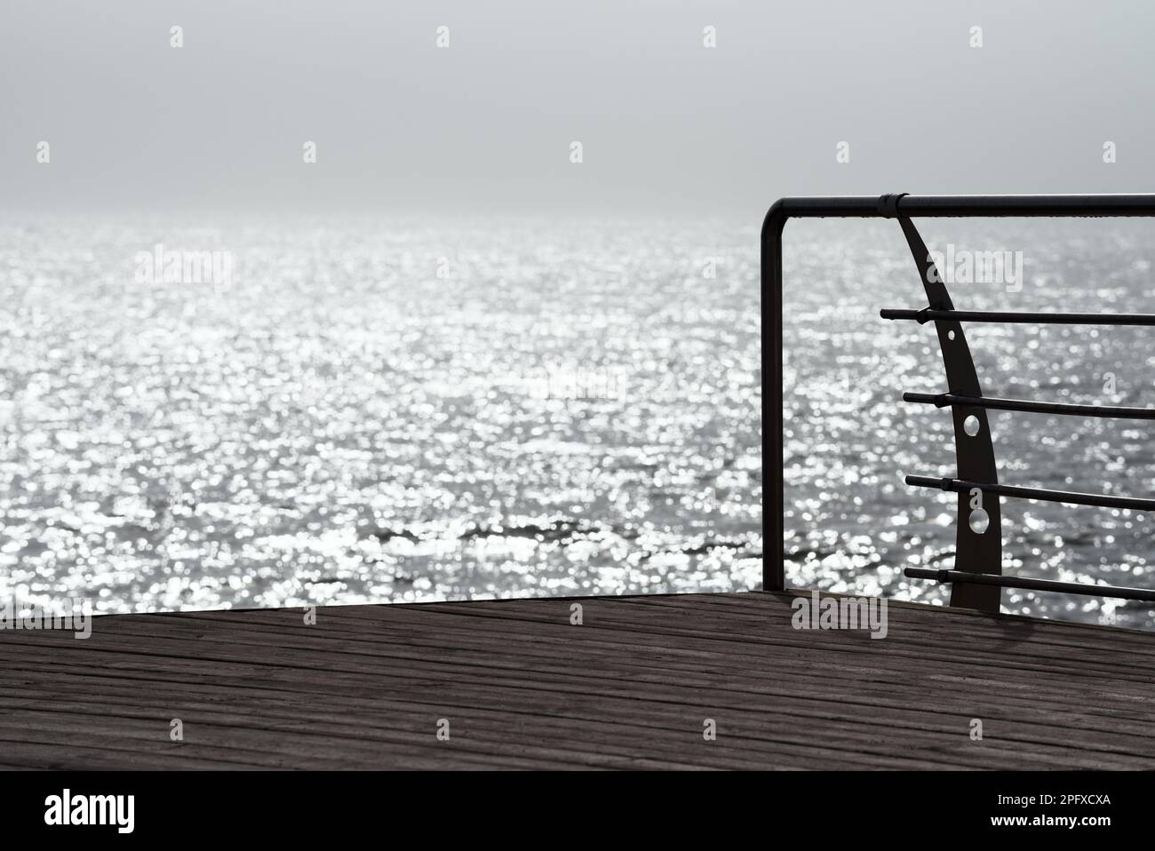 Morning coastal landscape. Solar glare in the sea water. Morning fog Stock Photo