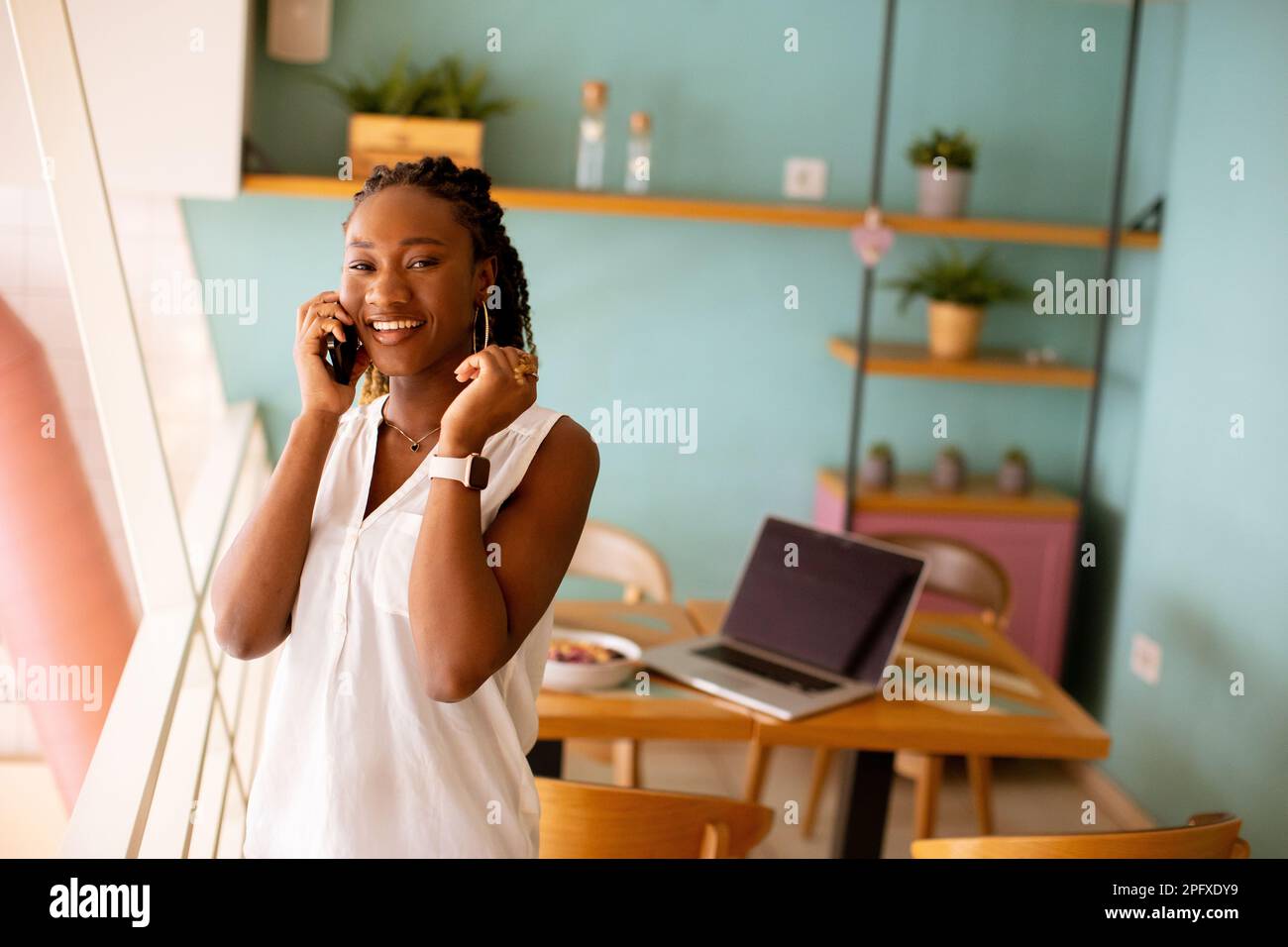 Young black woman using hi-res stock photography and images - Alamy