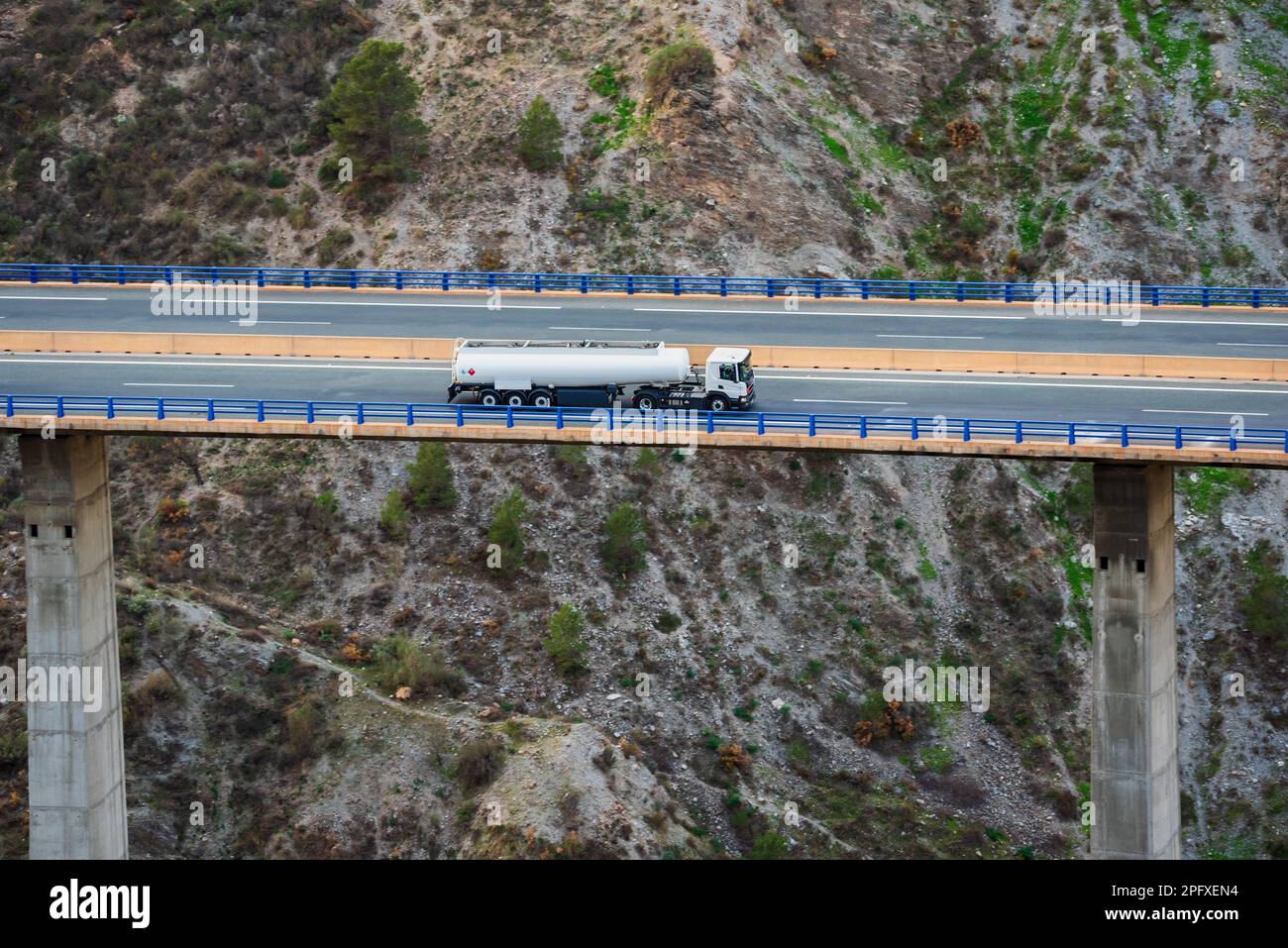 Fuel tanker truck with dangerous goods license plates circulating on a