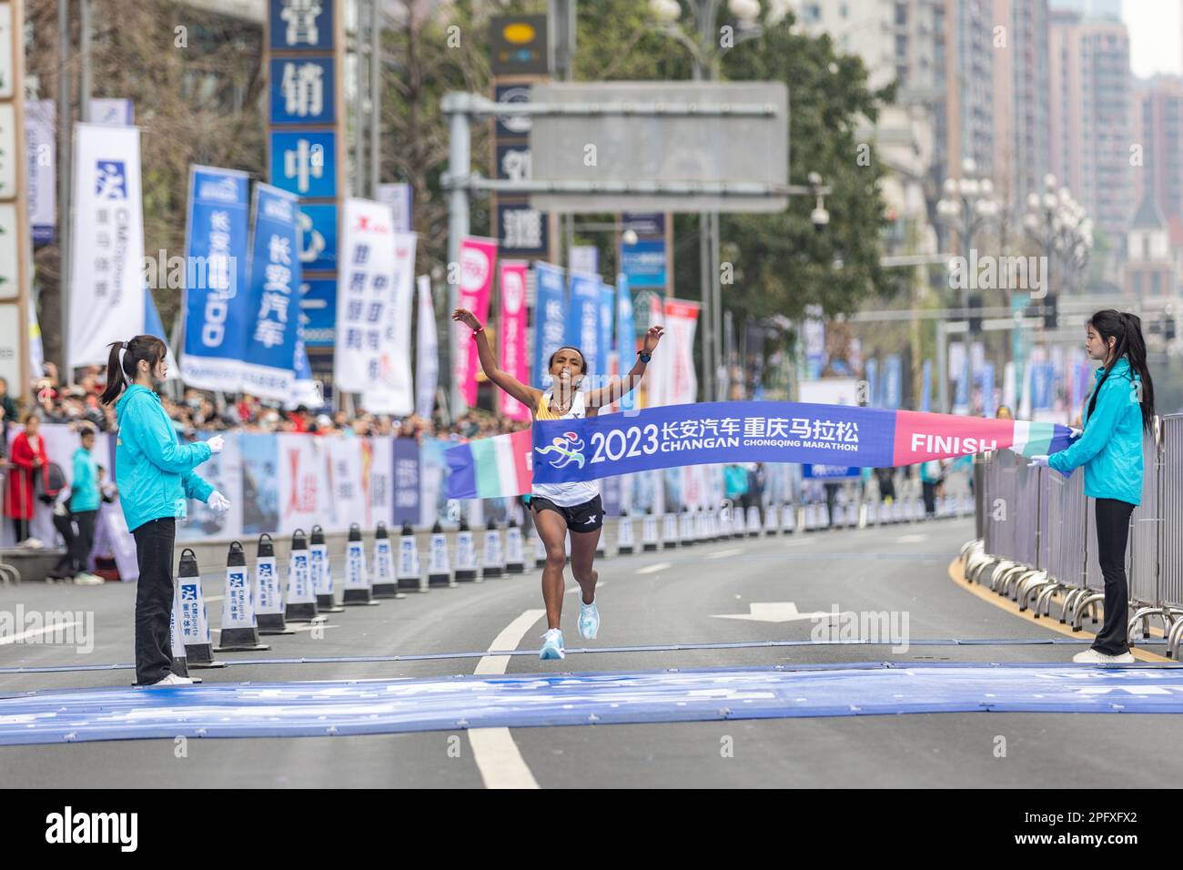 Chongqing. 19th Mar, 2023. Fantu Zewude Jifar (C) of Ethiopia crosses the finish line during the 2023 Chongqing Marathon in southwest China's Chongqing Municipality, March 19, 2023. Credit: Huang Wei/Xinhua/Alamy Live News Stock Photo