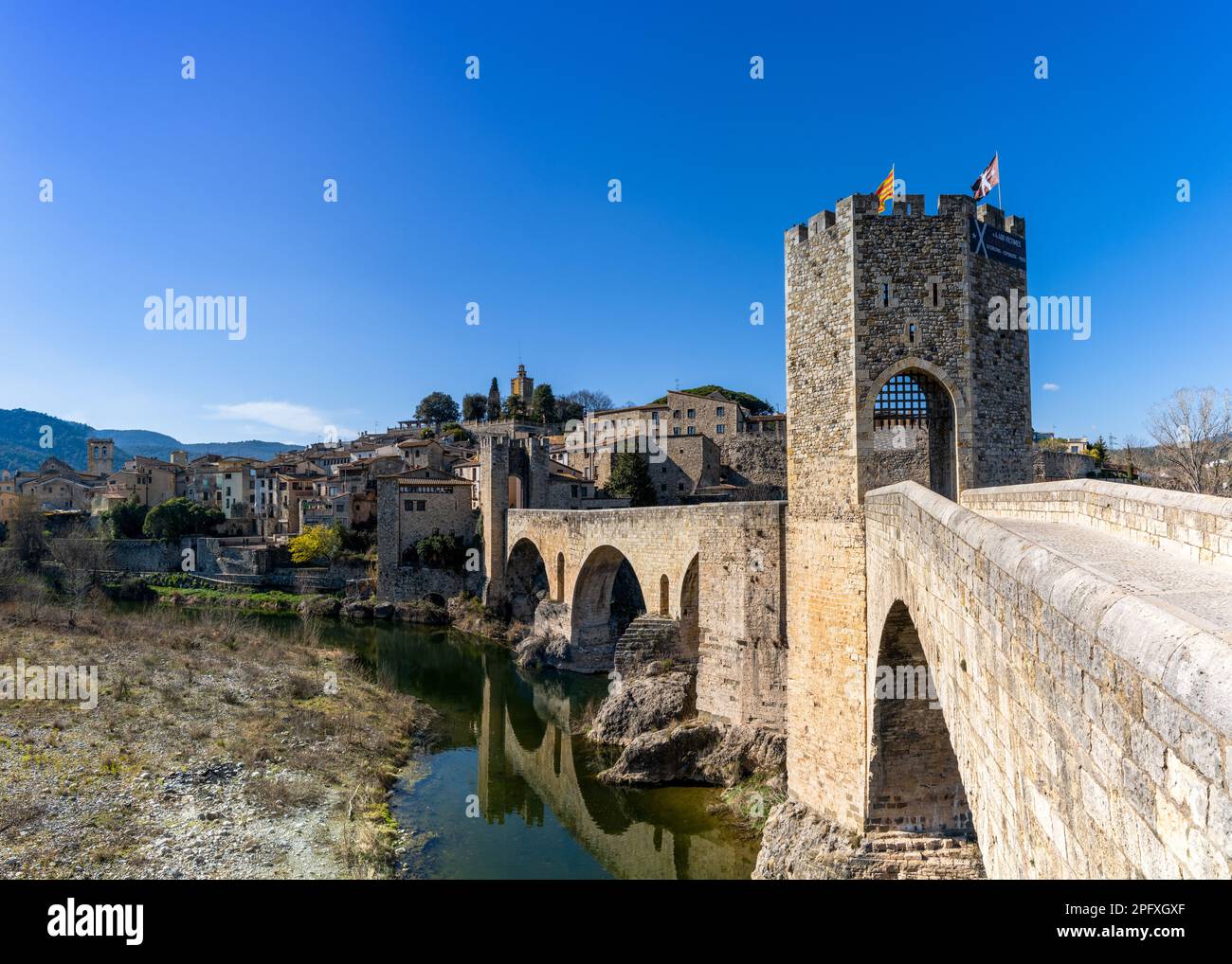 Besalu, Spain - 1 March, 2023: view of the medieval Romanesque bridge and village of Besalu in Catalonia Stock Photo
