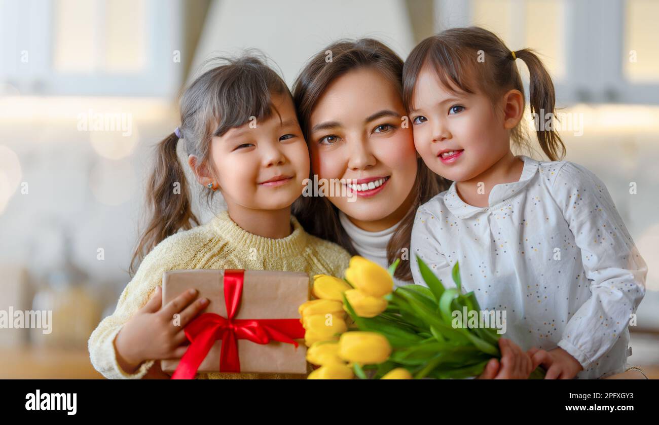 Happy mother's day. Children daughters congratulating their mother and ...