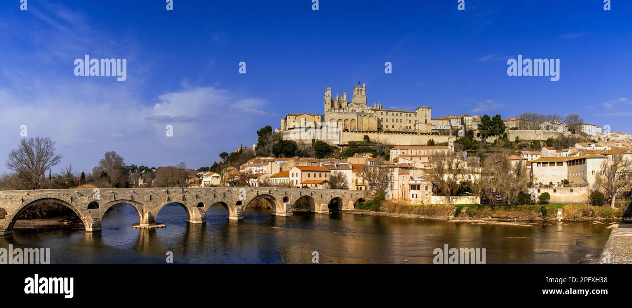 Beziers, France - 2 March, 2023: panorama view of the historic old town center of Beziers with Saint Nazaire Church and roman bridge over the river Or Stock Photo