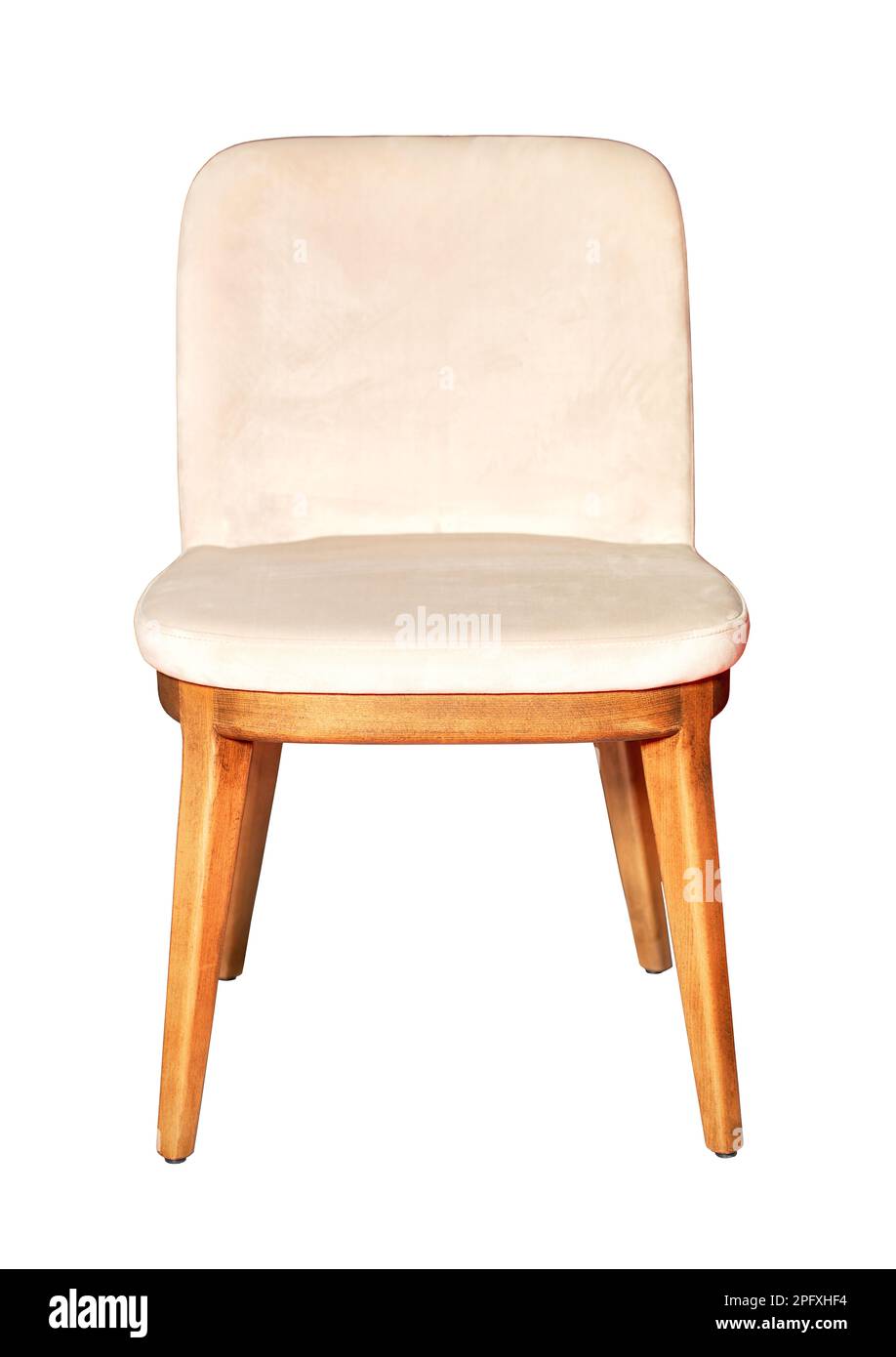 A comfortable dining chair with a wooden frame and cream velor upholstery. The image is isolated on a white background. Stock Photo