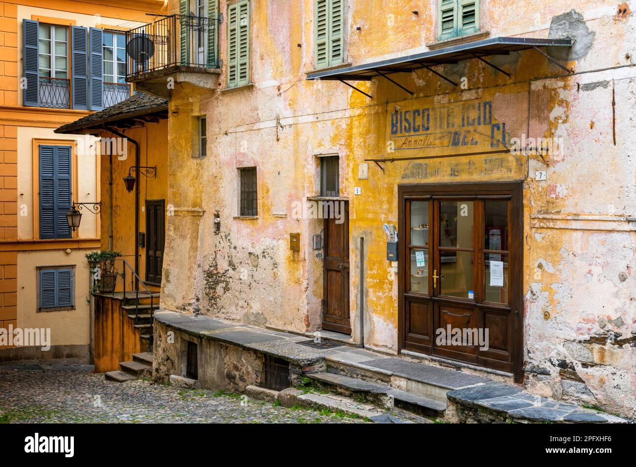 Orta San Giulio, Italy - 13 March, 2023: colorful shabby buildings in the old town center of Orta San Giulio Stock Photo